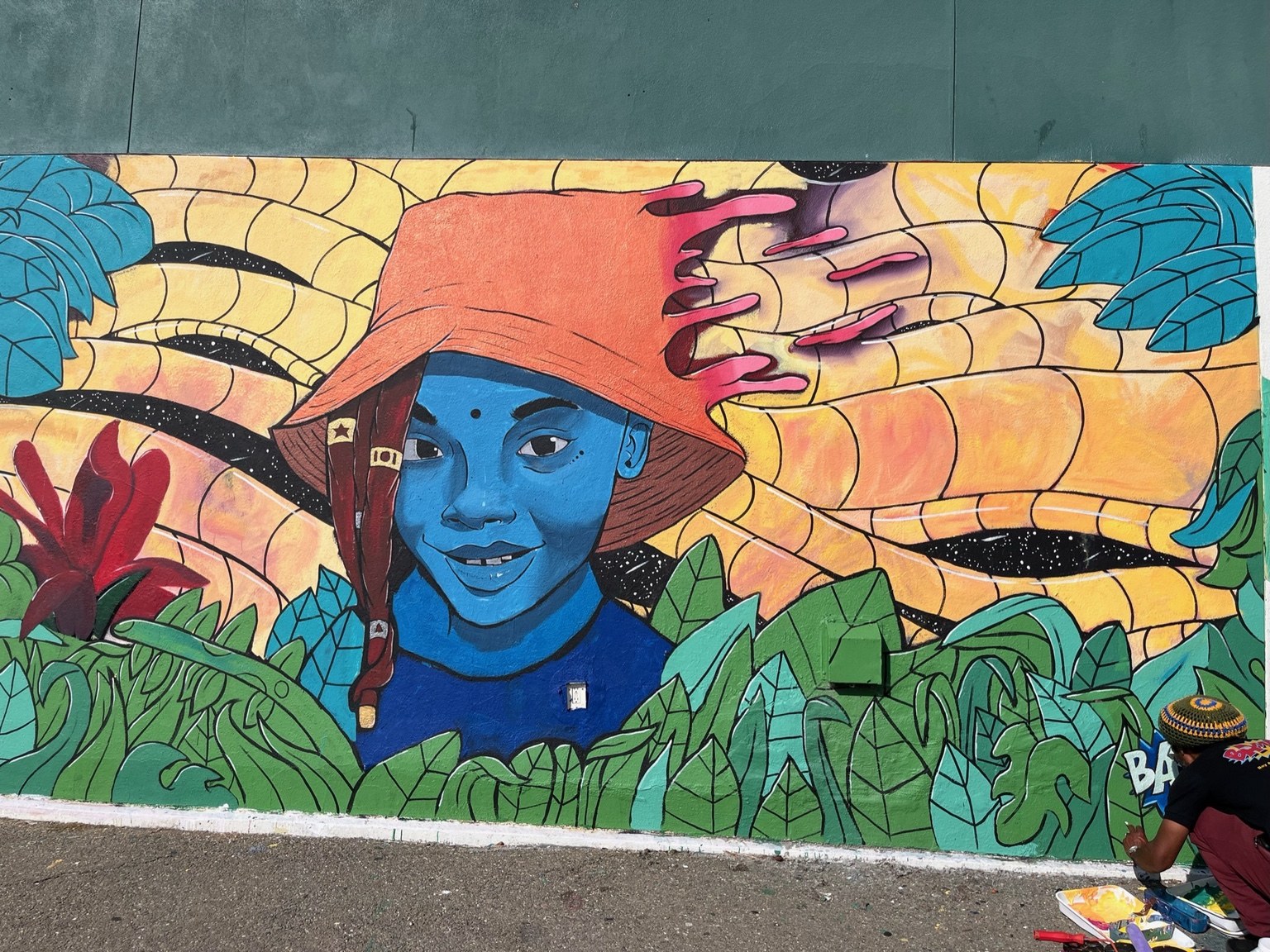 Colorful portrait mural with plants and flowing shapes